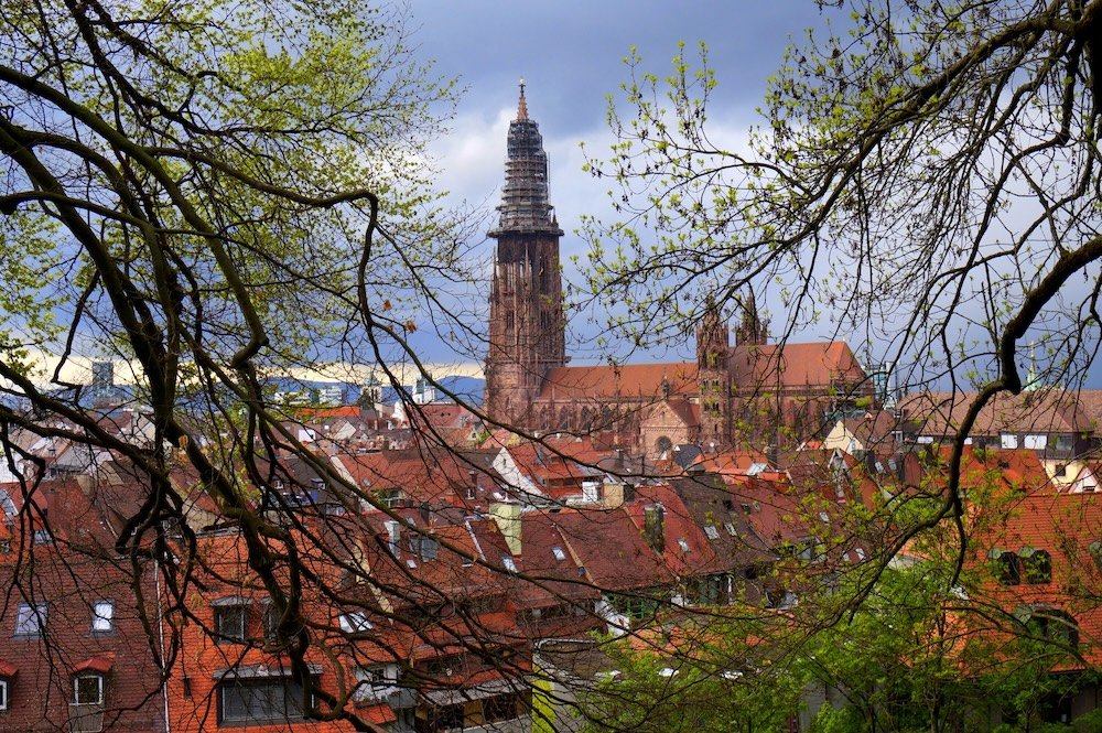 Freiburg old historic old town views with trees framing the scene in Germany 