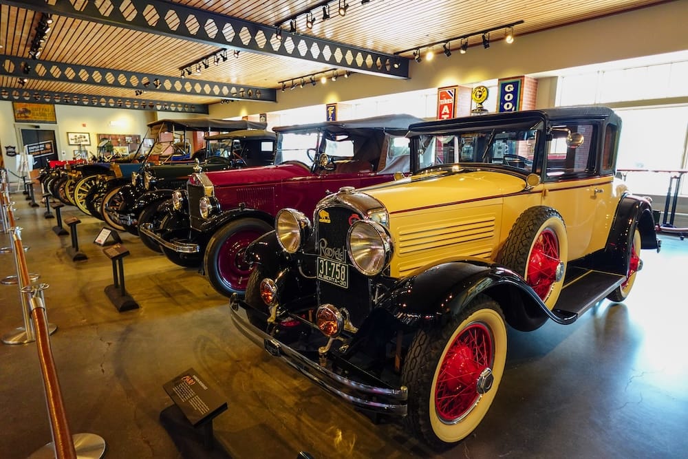 Gasoline Alley Museum Heritage Park Calgary Alberta Canada Vintage Cars and Historic Transportation A row of restored vintage automobiles is displayed inside Gasoline Alley Museum at Heritage Park in Calgary, Alberta, Canada, including a yellow-and-black classic car in the foreground.