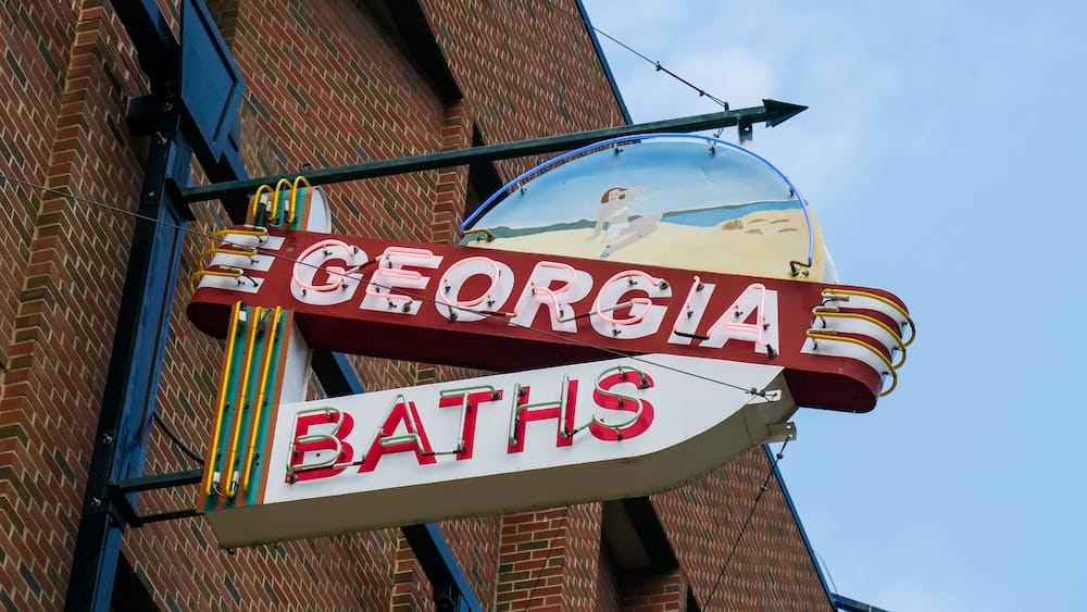 Georgia Baths neon sign at the Neon Sign Museum in downtown Edmonton, Alberta, Canada Vintage Georgia Baths neon sign mounted on a brick building at Edmonton’s outdoor Neon Sign Museum in downtown Edmonton, Alberta, Canada, beneath a pale blue sky.