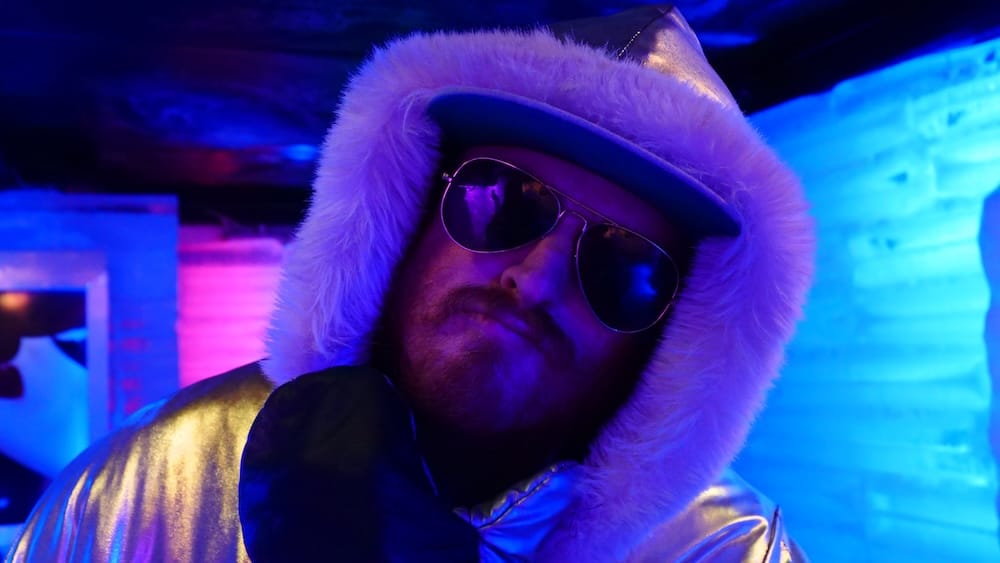 Samuel Jeffery inside Glacarium ice bar in El Calafate Patagonia wearing cold weather gear showing indoor activity option during siesta hours when shops and restaurants are closed.