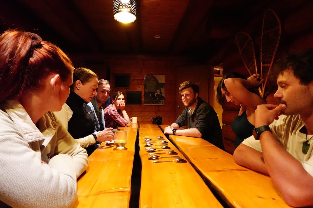 Group card game, lodge table, Banff National Park, Alberta, Canada A group gathers around a wooden lodge table playing the card game Spoons by lamplight in Banff National Park, Alberta, Canada, during an evening on a six-day backcountry horseback trek.