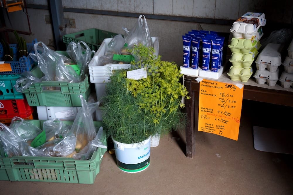 Egg cartons, fresh dill and bags of local produce displayed at a small farm stand near Hanko before the ingredients were taken into the kitchen for our Finnish farm-to-table meal.
