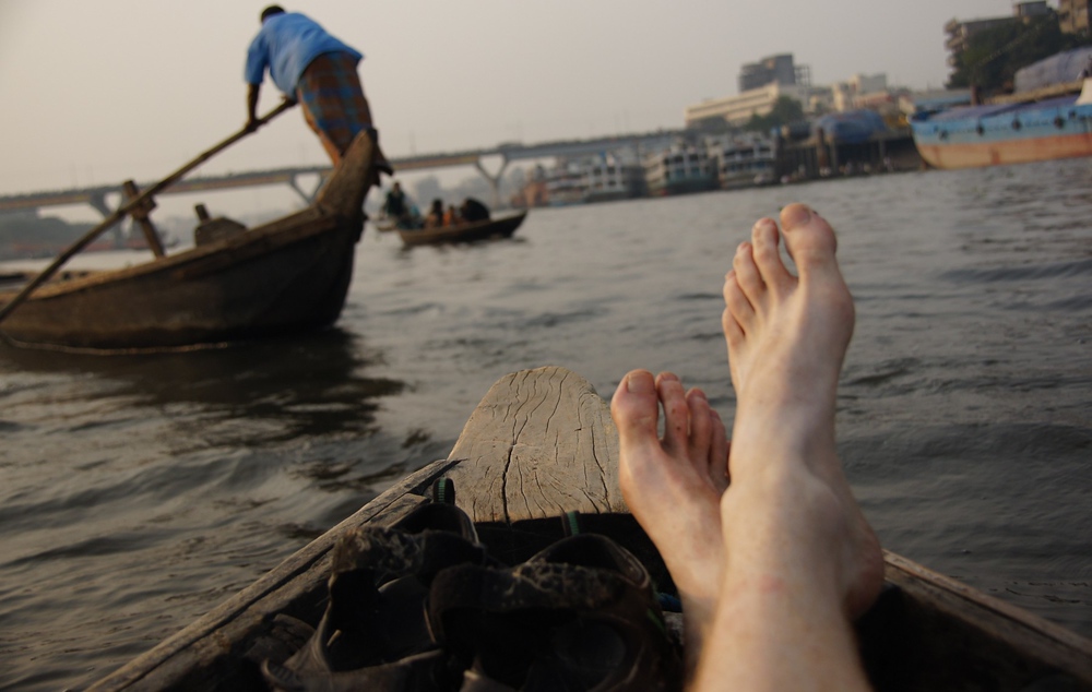 Here I am relaxing on the rowboat as we pass numerous other small vessels nearby the Sadarghat.
