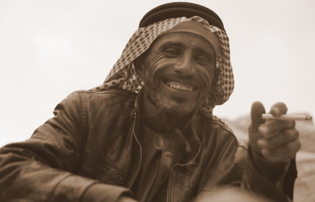 Here is a candid shot of a Bedouin man smoking a cigarette and beaming an even more impressive smile in Wadi Rum