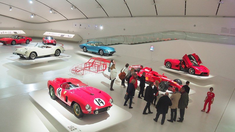 High vantage point of the 'Red Carpet' Ferrari exhibit at the Enzo Ferrari Museum in Modena