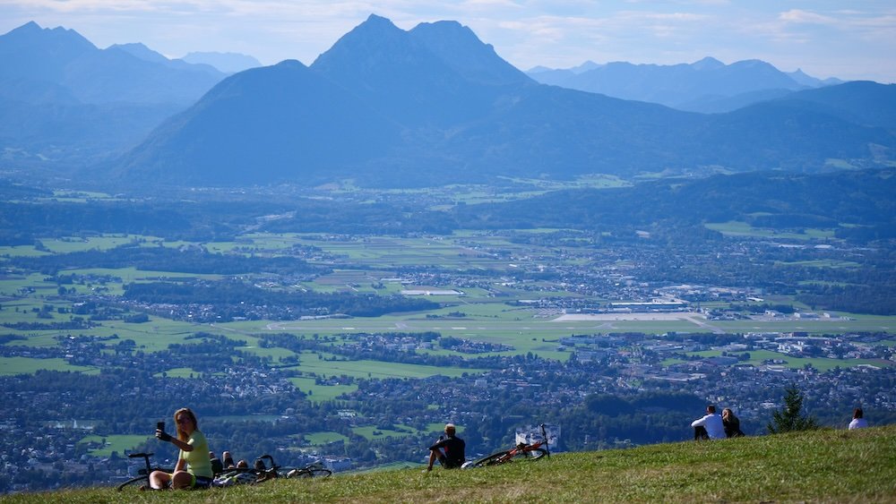 Hikers and visitors picnicking and taking a break in Gaisberg, Austria 