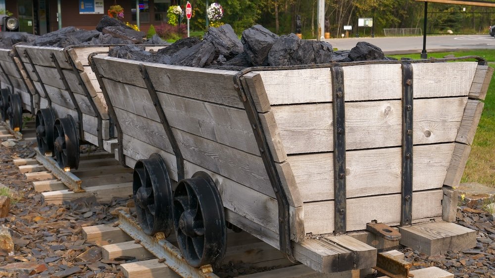 Historic coal mine carts in Fernie, BC Historic coal mine carts filled with black coal on display in Fernie, British Columbia, highlighting the mining industry that shaped the town’s early economy, labor history, and boom-and-bust cycles throughout the Elk Valley.