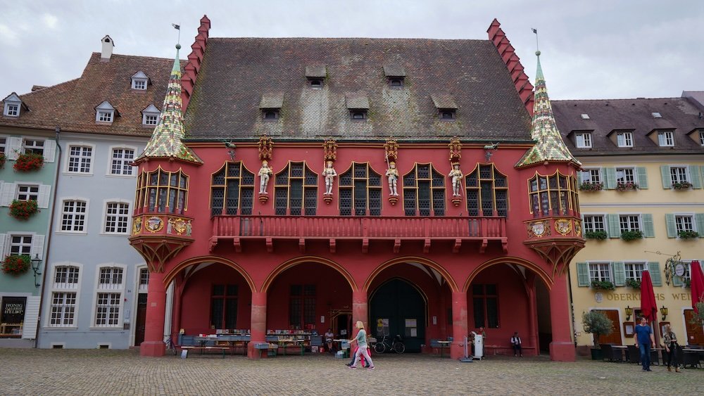 Historisches Kaufhaus red façade and ornate decorations testament to commercial past of Freiburg, Germany