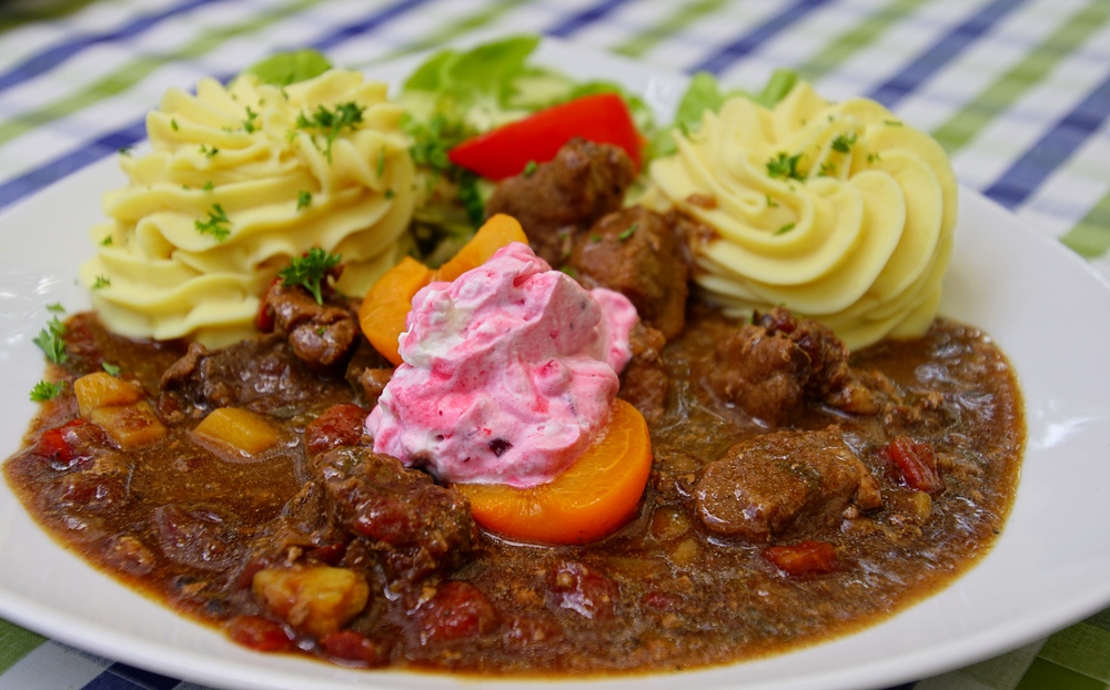 If you’re looking for a hearty meal while in Germany consider goulash, mashed potatoes, carrots and cranberry whipped cream