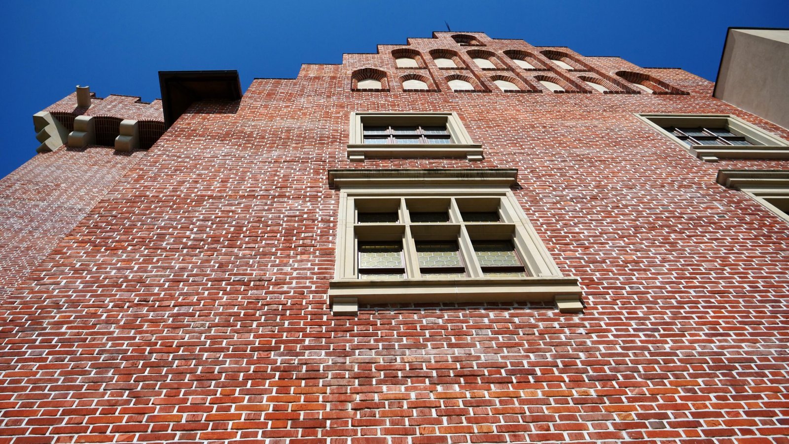 Imposing Royal Castle in Poznan Zamek Królewski w Poznaniu red brick towers from a unique low angle vantage point looking upwards in Poland 