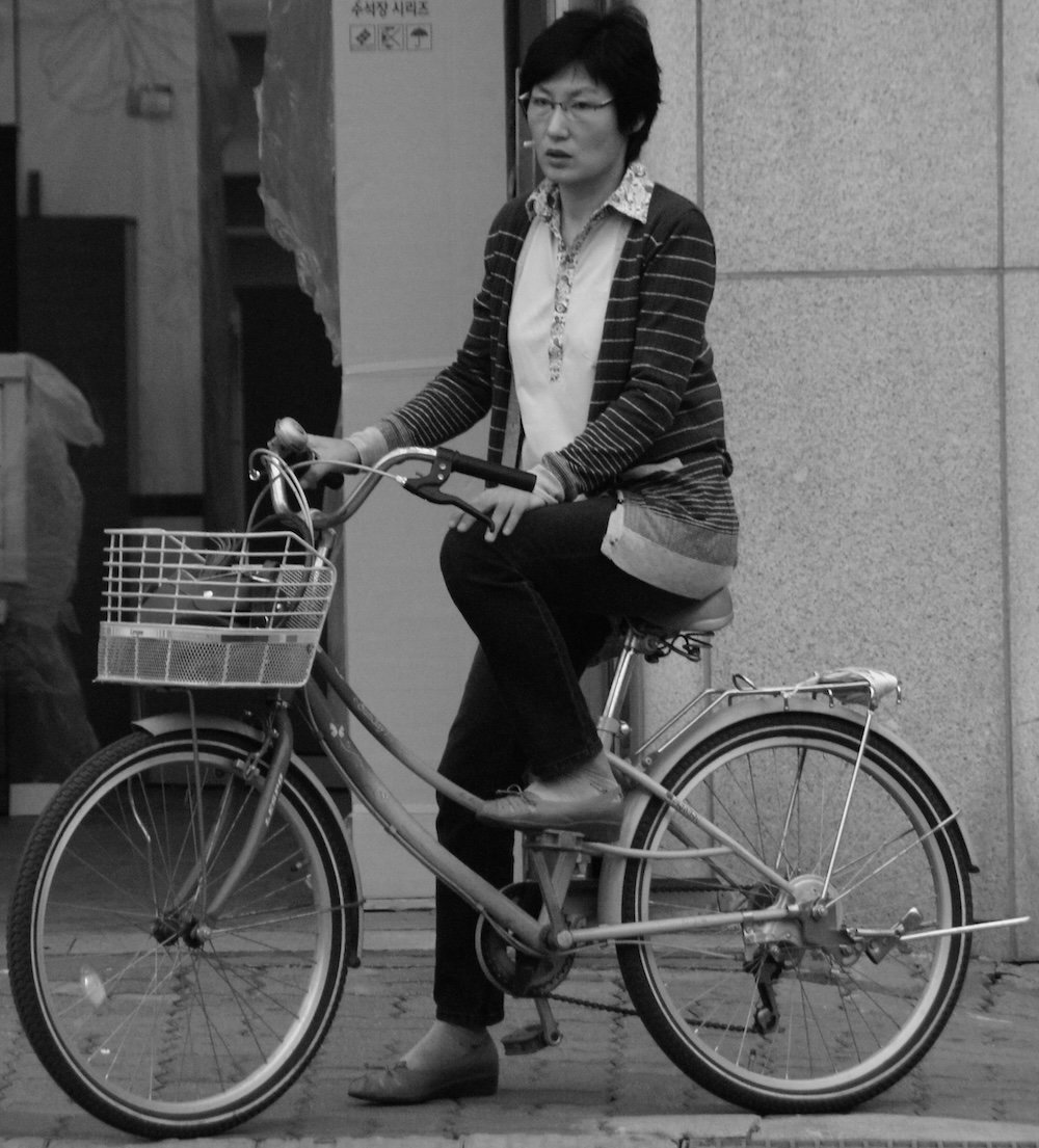 Incheon lady riding a bicycle greyscale 