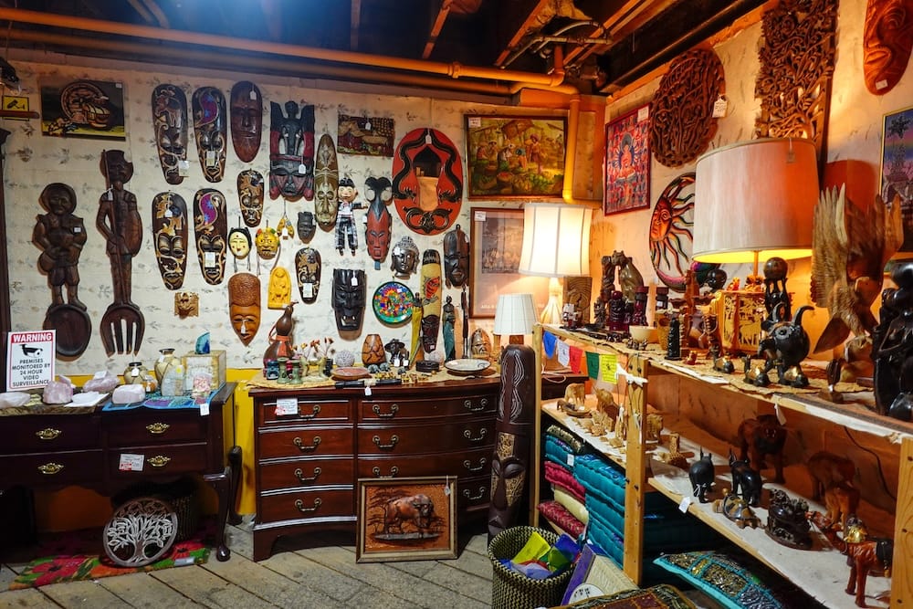 Independent vintage shop with masks and carvings in Old Strathcona, Edmonton, Alberta, Canada Interior of an independent Old Strathcona shop filled with carved masks, wooden figures, framed art, lamps, textiles and vintage furniture in Edmonton, Alberta, Canada.