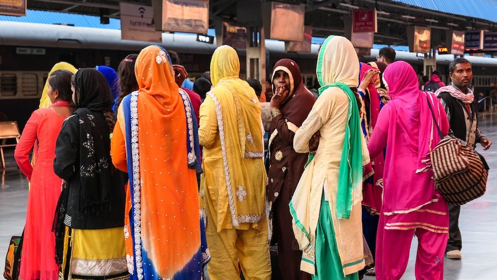 Indian women wearing colorful saris at the train station in Jodhpur, India 