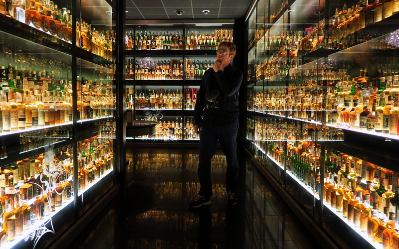 Inspecting all of the Whisky bottles on display at the Edinburgh Whisky Experience tour in Edinburgh, Scotland