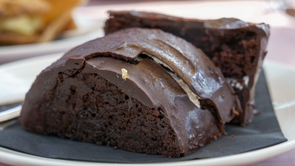 Island Lake Lodge near Fernie, British Columbia, featuring the Elevated Jos Louis dessert at Bear Bistro, with rich chocolate cake and glossy icing served as a decadent post-hike treat surrounded by alpine lodge atmosphere and mountain dining vibes.