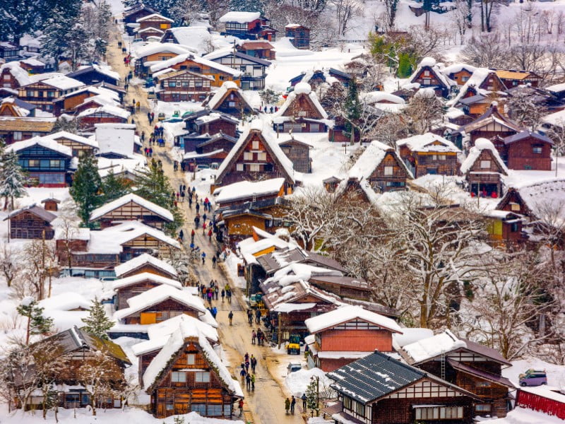 Japanese traditional winter village covered in a blanket of snow in the wintertime - Shirakawago, Japan