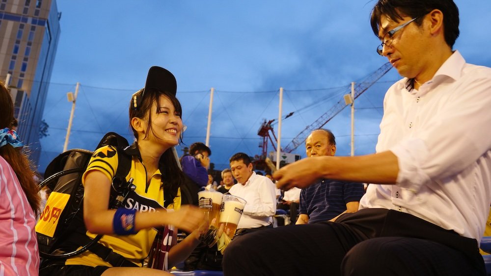 Japanese hostess dispensing beer at a baseball game in Japan