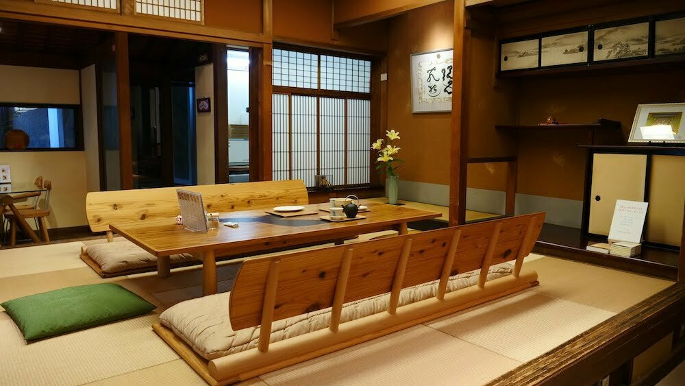 Japanese traditional tea ceremony sitting quarters on the floor with mats, table and back rest in Japan 