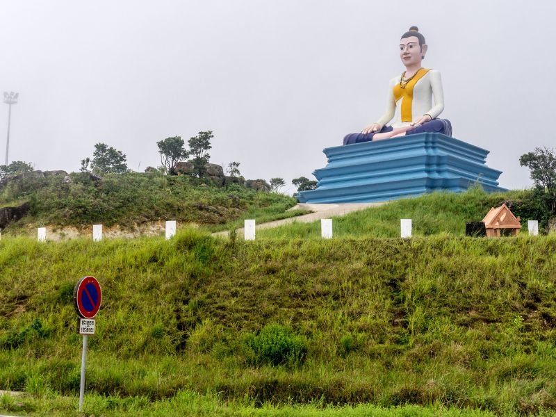 Kampot roadside attraction with statue on top of the hill in Cambodia