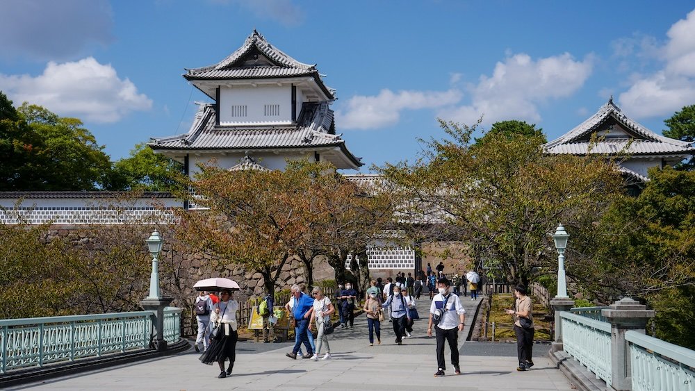 Kanazawa Castle pedestrians crossing a bridge 