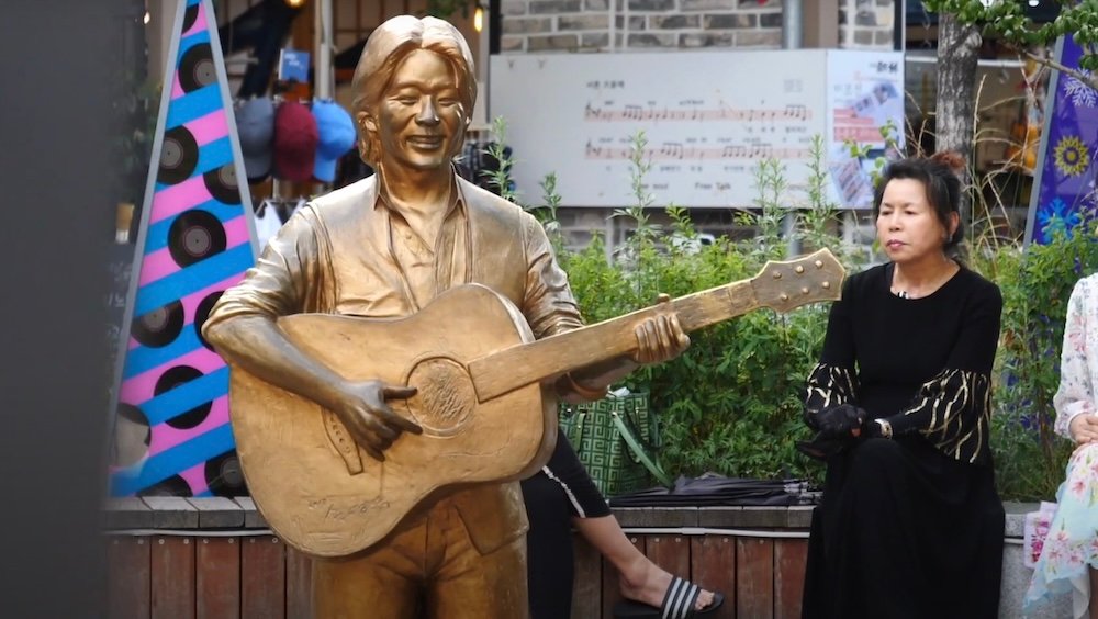 Kim Gwangseok-gil Street statue with locals admiring it in Daegu, South Korea