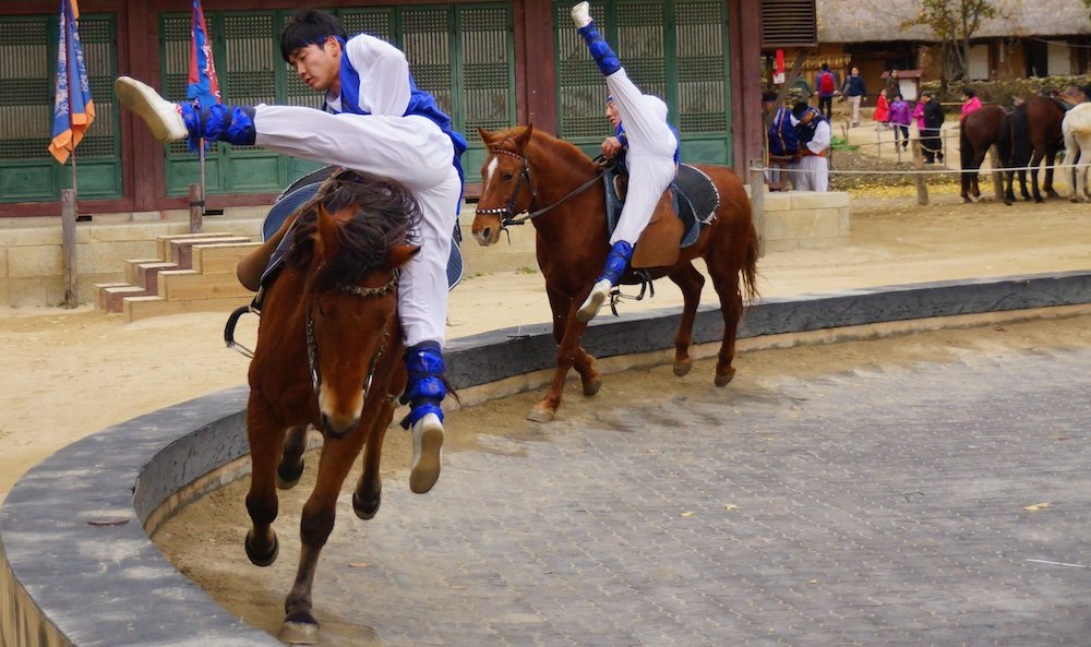 Korean Folk Village talented performers jumping on and off horses in Yongin, South Korea 