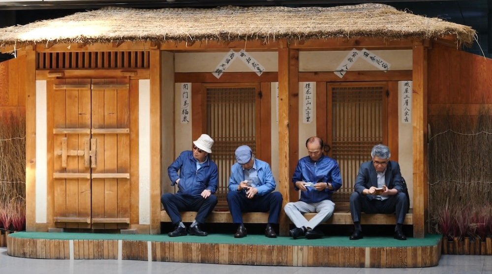 Korean men waiting to take the train in Daegu, Korea 