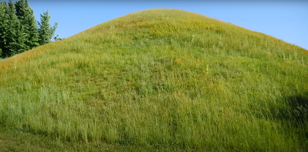 Korean traditional tomb mound in Gyeongju, South Korea featuring green grass