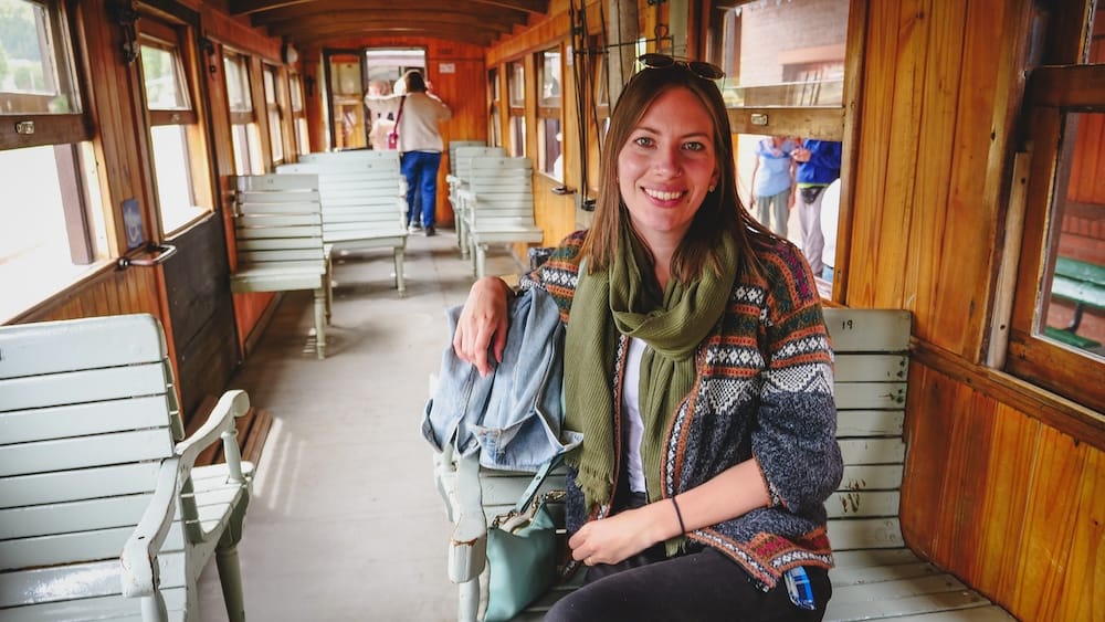 Historic La Trochita Steam Train Interior in Esquel Chubut and Patagonia Month-by-Month Cultural Travel, Audrey Bergner Audrey Bergner seated inside the historic La Trochita steam train in Esquel, Chubut, showing how Patagonia month-by-month planning also includes seasonal cultural experiences and slower heritage travel beyond just hiking and wildlife, with Audrey Bergner.