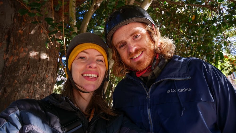 Audrey Bergner and Samuel Jeffery near Lago Gutiérrez, Bariloche, Patagonia, Argentina Audrey Bergner and Samuel Jeffery smile beneath leafy trees while wearing riding helmets near Lago Gutiérrez in Bariloche, Río Negro, Patagonia, Argentina.