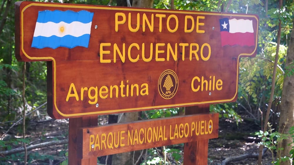 Border sign between Argentina and Chile in Lago Puelo National Park Patagonia where many travelers assume crossings are simple, but regulations, documentation, and access points can complicate travel plans