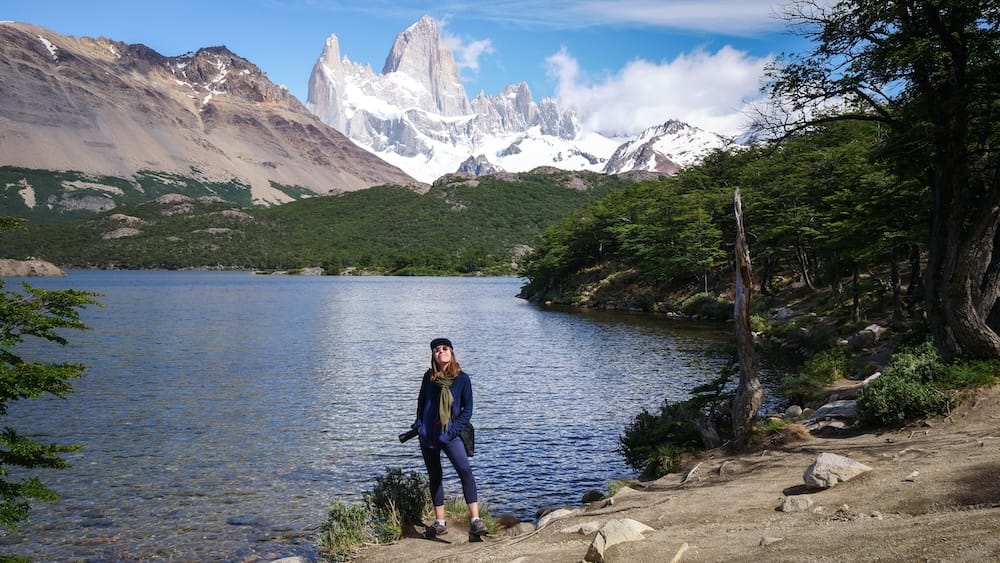 Audrey Bergner at Laguna Capri, Mount Fitz Roy, El Chaltén, Santa Cruz Province, Patagonia Audrey Bergner stands beside Laguna Capri near El Chaltén, Santa Cruz Province, Argentine Patagonia, with the granite spires of Mount Fitz Roy rising above forested slopes across the water.