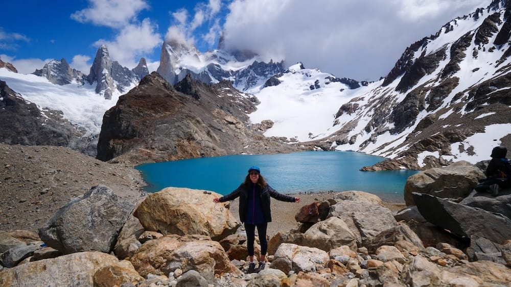 Audrey Bergner at Laguna de los Tres with Mount Fitz Roy in El Chaltén Patagonia Argentina after a challenging hike showing the dramatic glacial lake and jagged Andes peaks that define mountain Patagonia.
