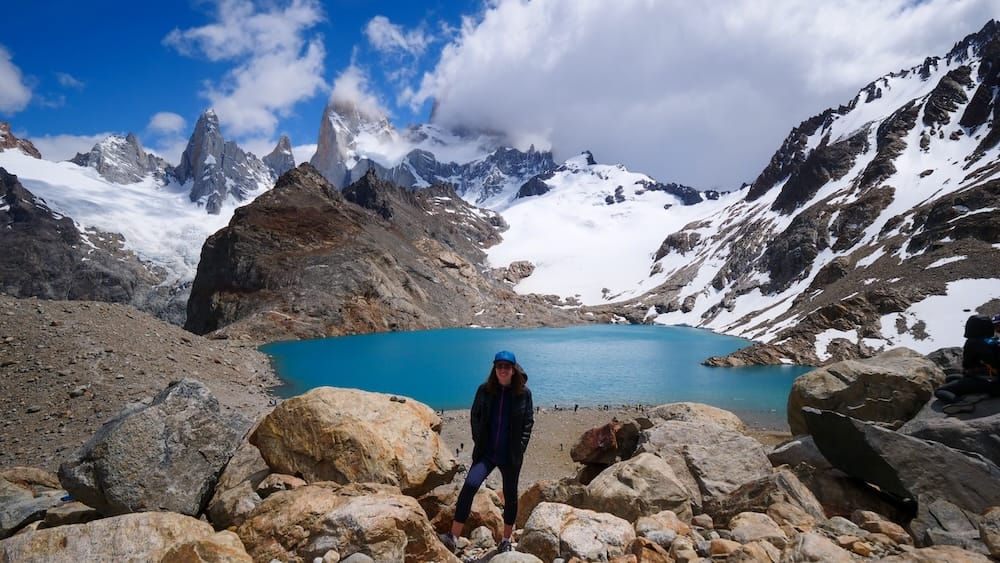 Audrey Bergner at Laguna de los Tres in El Chalten Patagonia standing beside the turquoise lake below Fitz Roy where the final reveal delivers an overwhelming sense of scale that photos struggle to fully capture