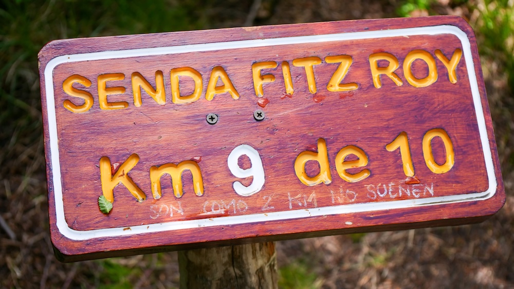 Laguna de los Tres trail in El Chaltén, Patagonia, showing the wooden “Senda Fitz Roy Km 9 de 10” sign that marks the steep, rocky final climb where the hike gets toughest and fitness is truly tested.