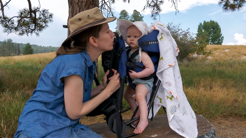 Family-friendly visit to Lake Elizabeth in Cranbrook, BC with Audrey Bergner and baby Aurelia Lake Elizabeth in Cranbrook, BC during a peaceful family visit, with Audrey Bergner spending time with baby Aurelia in a carrier beside the wetland trail, highlighting how calm, scenic walks here are ideal for parents traveling with babies and toddlers.