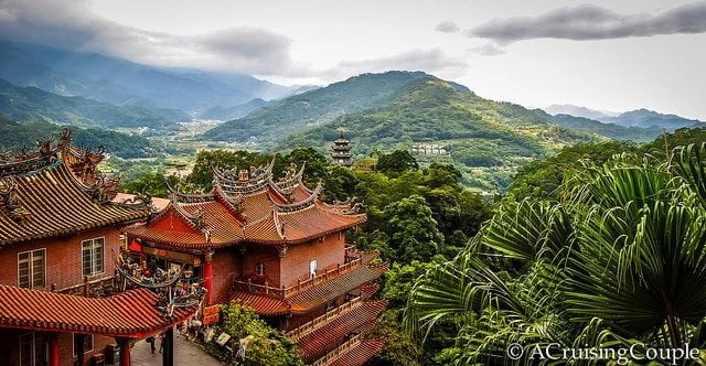 Lions Head Mountain Taiwan overlooking traditional architecture and lush rolling mountains off in the distance