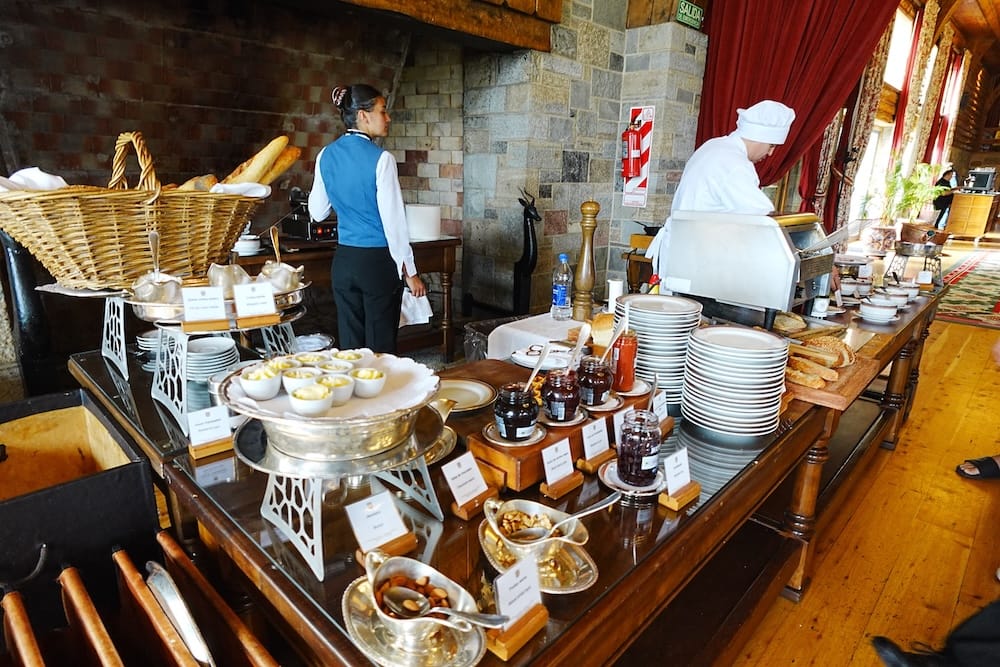 Breakfast Buffet and Omelette Station at Llao Llao Hotel, Bariloche, Río Negro, Patagonia, Argentina Breakfast buffet service at Llao Llao Hotel in Bariloche, Río Negro, Patagonia, Argentina, with jars of preserves, bread baskets, plated dishes and a chef working at the hot station inside the wood-and-stone lodge dining room.