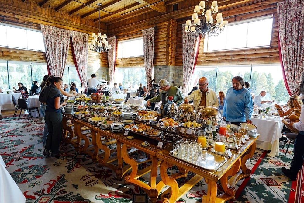 Breakfast buffet with pastries, fruit, juices and hot dishes inside the timber dining room at Llao Llao Hotel near Bariloche, Río Negro, Patagonia, Argentina.