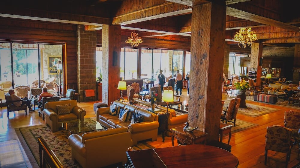 Lobby Bar Lounge Interior at Llao Llao Hotel, Bariloche, Río Negro, Patagonia, Argentina Wide interior view of the Lobby Bar at Llao Llao Hotel in Bariloche, Río Negro, Patagonia, Argentina, with leather seating, timber columns, wood floors, chandeliers and bright windows overlooking the resort grounds.