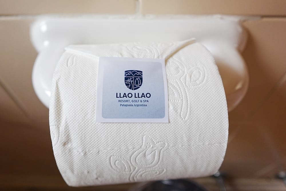 Branded toilet paper roll inside a bathroom at Llao Llao Resort in Bariloche, Río Negro, Argentina, wrapped with the hotel’s crest and “Patagonia Argentina” label.