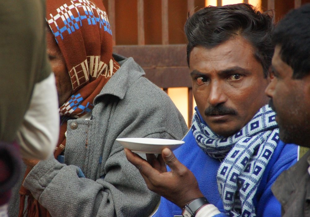 Locals enjoying street food and tea in Agra, India