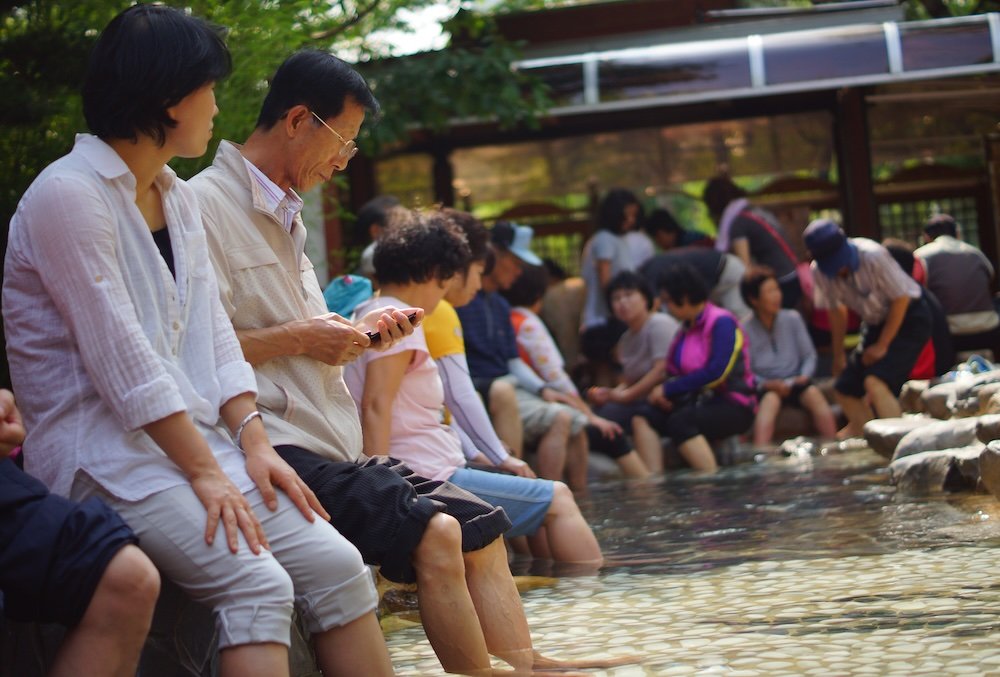 Locals enjoying the public foot bath in Daejeon, South Korea 