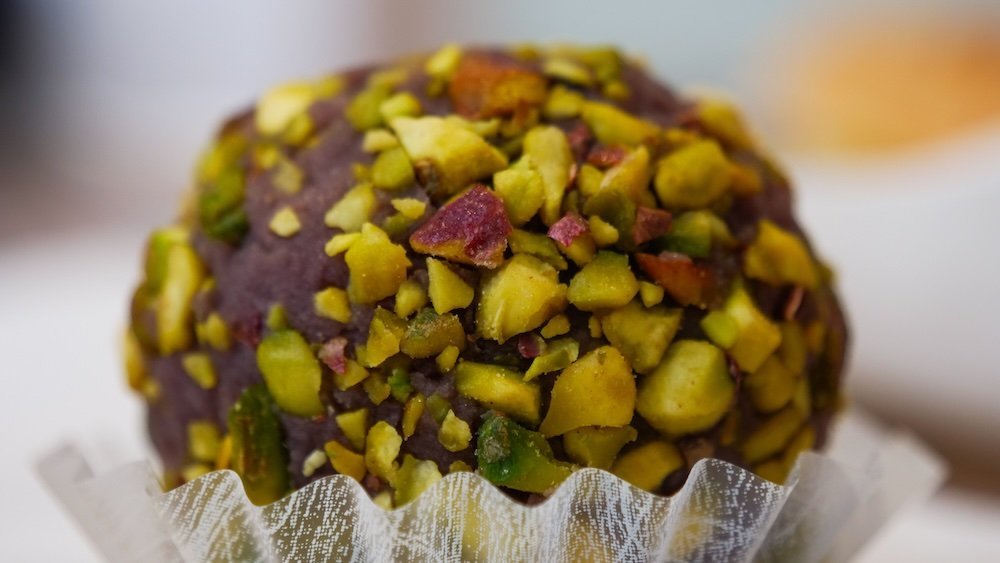 macro details of a chocolate mochi covered with pistachios at The Matcha Cafe for Mochi in Niigata, Japan 