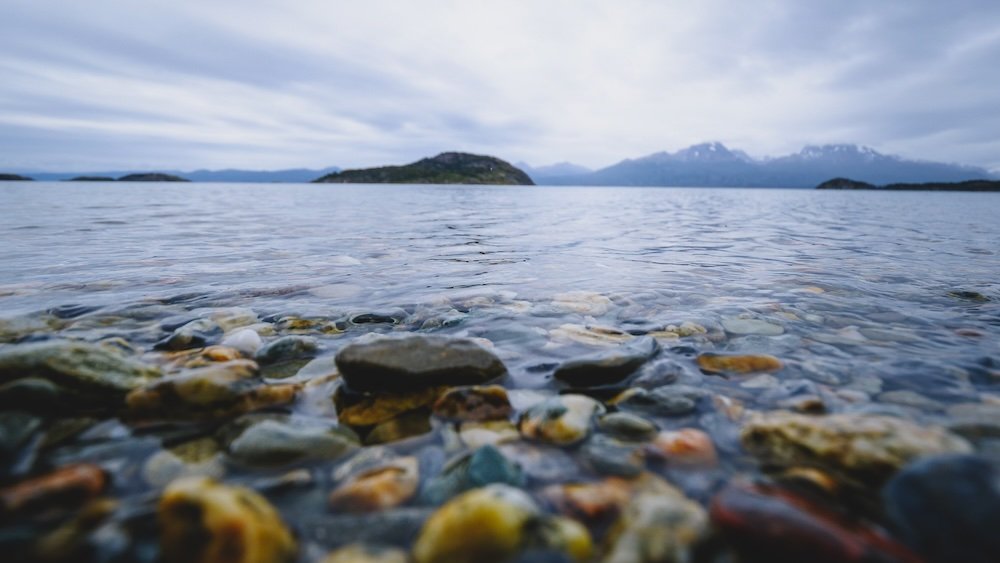 Macro rock details in the foreground of a lake in Tierra del Fuego National Park in Ushuaia, Argentina 