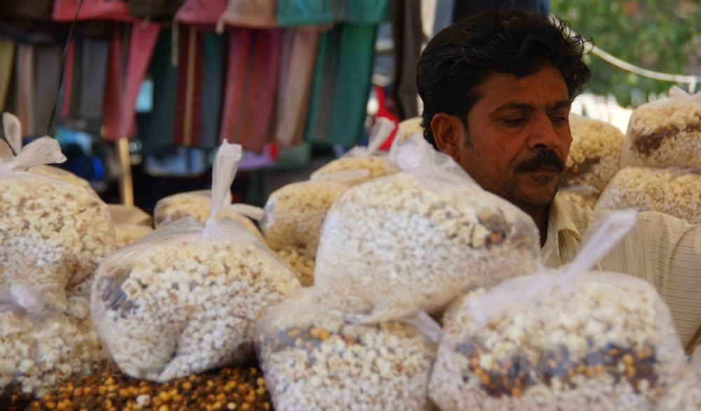 Man selling snacks at the Sardar Market in Jodhpur, India 