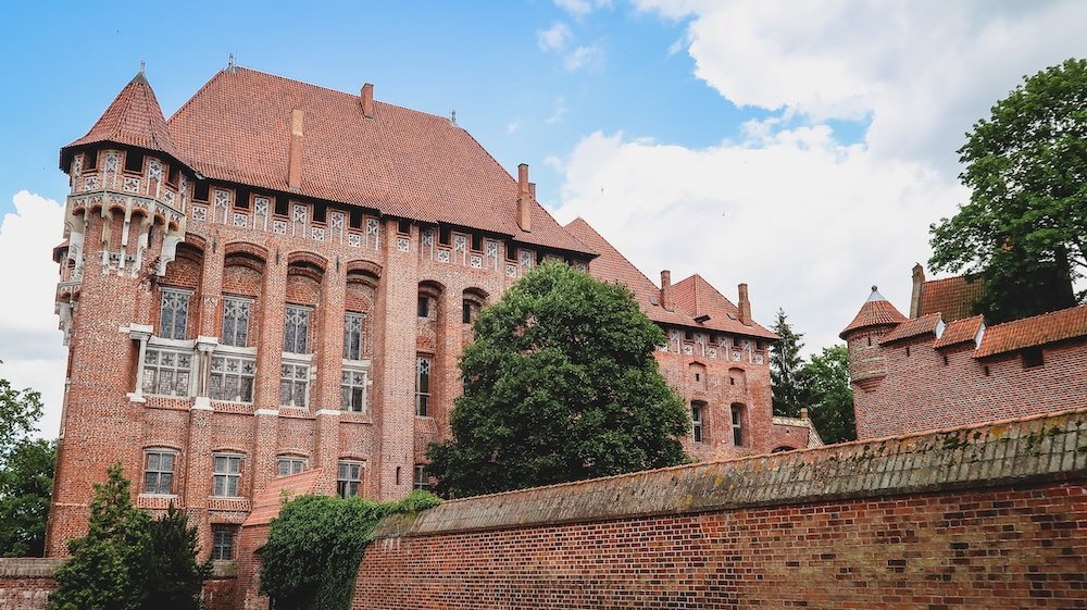 Marvel at Malbork Castle’s Grand Exterior constructed mainly of red brick in Poland