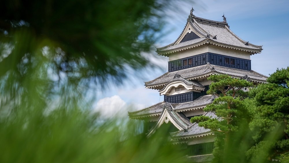 Matsumoto Castle creatively framed with branches in Japan 