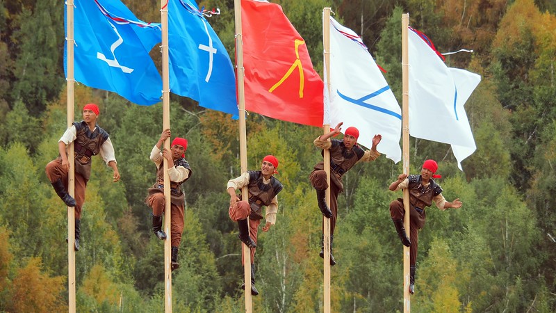 Men climbing a pole during a cultural performance at the World Nomad Games in Kyrgyzstan