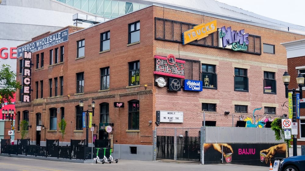 Mercer Warehouse near Rogers Place and the Neon Sign Museum in downtown Edmonton, Alberta, Canada The historic brick Mercer Warehouse on 104 Street in downtown Edmonton, Alberta, Canada, displays colourful signs and restaurant entrances with the curved Rogers Place roof rising behind it.